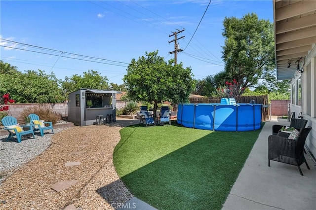 9811 Kempster Ave, Fontana, CA 92335 - fenced backyard featuring a patio area and an outbuilding