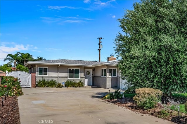 9811 Kempster Ave, Fontana, CA 92335 - view of front of house featuring a gate, stucco siding, and a chimney
