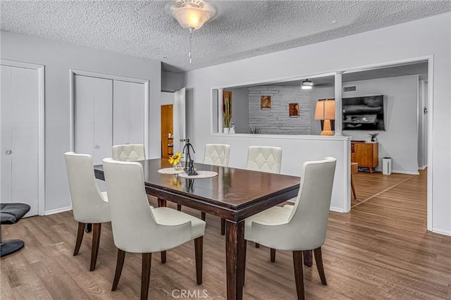 9811 Kempster Ave, Fontana, CA 92335 - dining room with wood finished floors and a textured ceiling