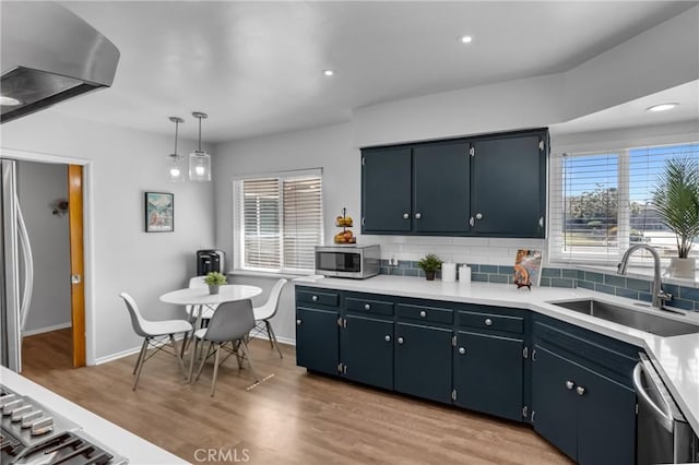 9811 Kempster Ave, Fontana, CA 92335 - kitchen featuring stainless steel appliances, tasteful backsplash, light wood-style floors, light countertops, and recessed lighting