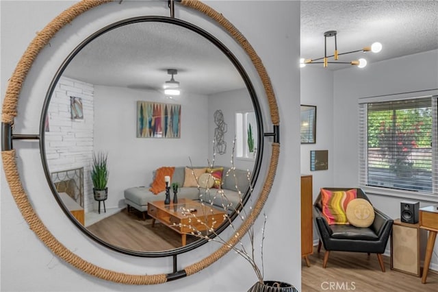 9811 Kempster Ave, Fontana, CA 92335 - living area with a textured ceiling, a chandelier, and wood finished floors