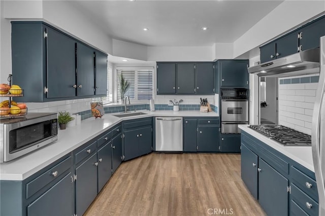 9811 Kempster Ave, Fontana, CA 92335 - kitchen featuring appliances with stainless steel finishes, a warming drawer, under cabinet range hood, decorative backsplash, and recessed lighting