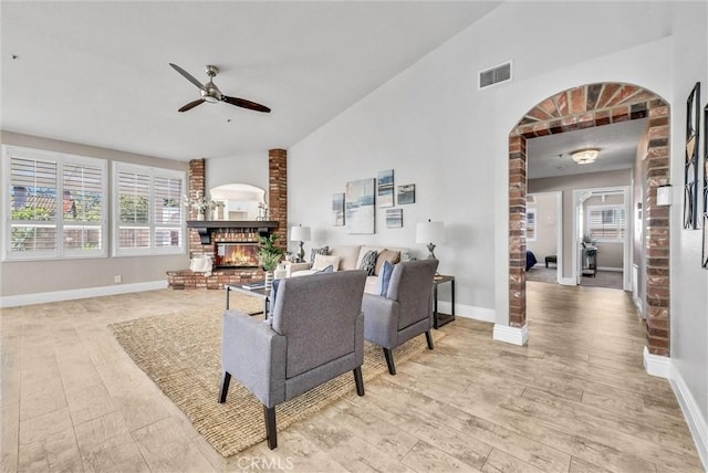 5560 Feather Grass Ln, Yorba Linda, CA 92887 - living room with a ceiling fan, lofted ceiling, arched walkways, light wood-style floors, and a fireplace