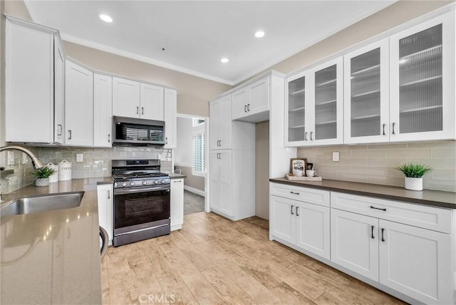 5560 Feather Grass Ln, Yorba Linda, CA 92887 - kitchen featuring stainless steel appliances, decorative backsplash, glass insert cabinets, light wood-style floors, and recessed lighting