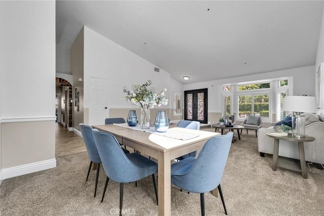 5560 Feather Grass Ln, Yorba Linda, CA 92887 - dining area featuring light colored carpet, high vaulted ceiling, and arched walkways