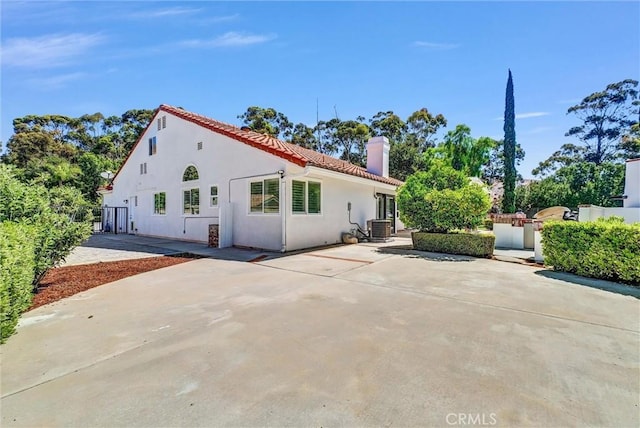 5560 Feather Grass Ln, Yorba Linda, CA 92887 - view of front of property featuring a chimney, a patio, stucco siding, and a tiled roof