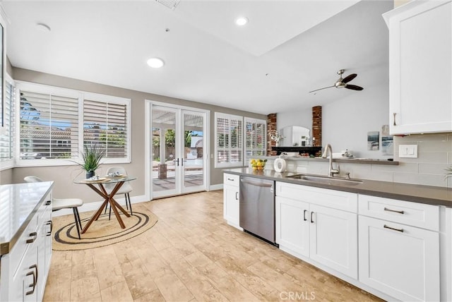 5560 Feather Grass Ln, Yorba Linda, CA 92887 - kitchen with stainless steel dishwasher, dark countertops, a ceiling fan, white cabinets, and light wood-style floors