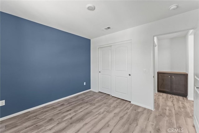 26627 Pearl Blossom Way, Menifee, CA 92585 - unfurnished bedroom featuring wood finished floors and a closet