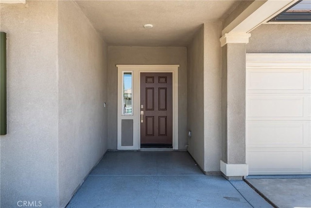 26627 Pearl Blossom Way, Menifee, CA 92585 - doorway to property featuring stucco siding and a garage