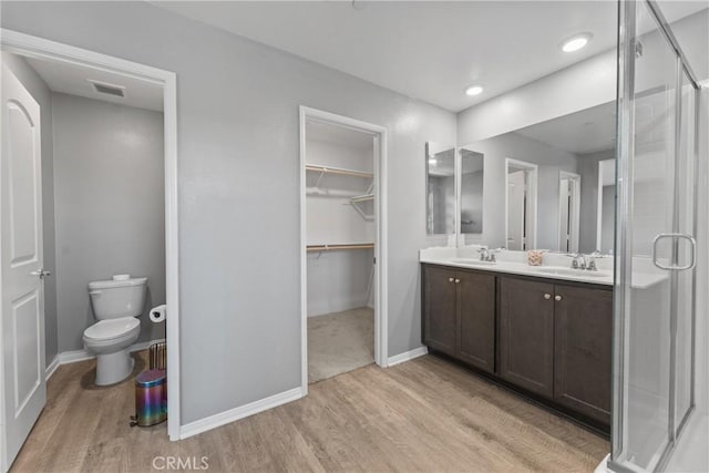 26627 Pearl Blossom Way, Menifee, CA 92585 - bathroom with wood finished floors, a stall shower, double vanity, and recessed lighting