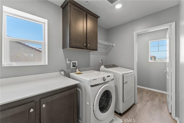 26627 Pearl Blossom Way, Menifee, CA 92585 - washroom featuring cabinet space, separate washer and dryer, and light wood-type flooring