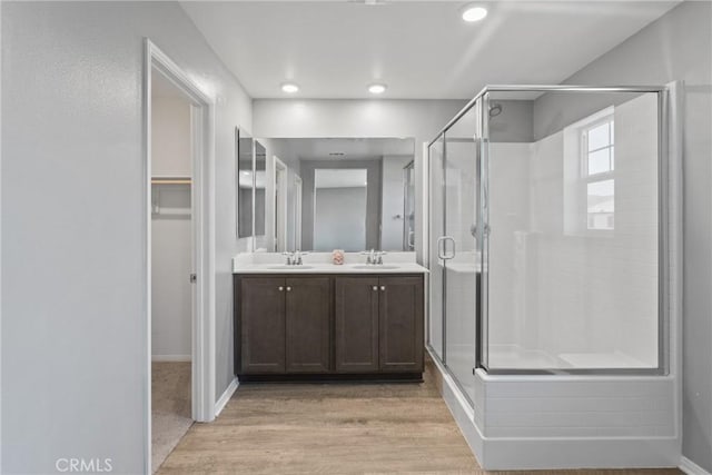 26627 Pearl Blossom Way, Menifee, CA 92585 - full bath featuring a stall shower, wood finished floors, double vanity, a spacious closet, and recessed lighting
