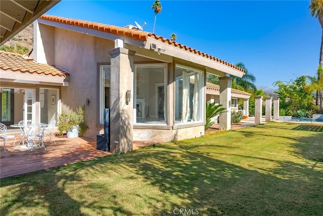 940 N Silent Ranch Dr, Glendora, CA 91741 - back of property with a tiled roof, stucco siding, a lawn, and a patio area