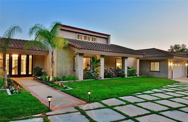 940 N Silent Ranch Dr, Glendora, CA 91741 - mediterranean / spanish-style home with a garage, a lawn, french doors, and a tile roof