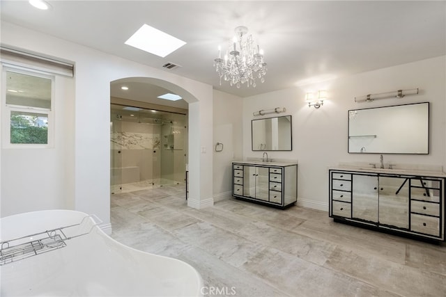940 N Silent Ranch Dr, Glendora, CA 91741 - bathroom featuring a stall shower, two vanities, a freestanding tub, a chandelier, and recessed lighting