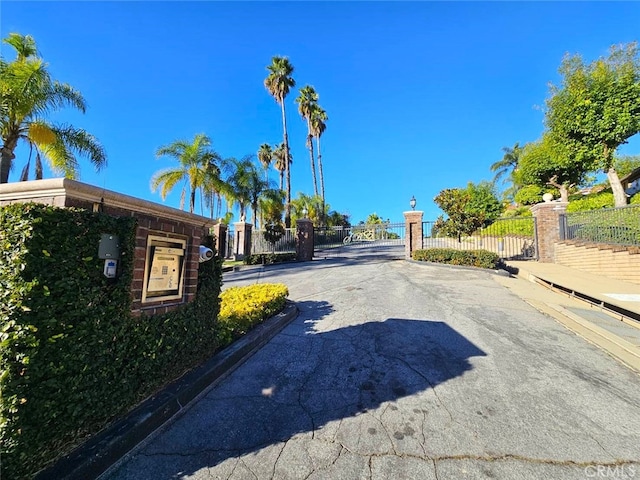 940 N Silent Ranch Dr, Glendora, CA 91741 - view of asphalt road featuring curbs, a gate, and a gated entry