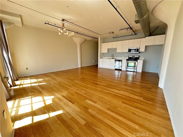 200 N San Fernando Rd Unit 313, Los Angeles, CA 90031 - unfurnished living room featuring light wood-type flooring and a sink