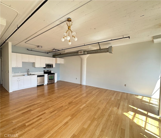 200 N San Fernando Rd Unit 313, Los Angeles, CA 90031 - unfurnished living room featuring light wood-style floors and a chandelier