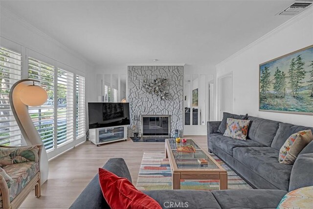 1011 Portola Dr, Arcadia, CA 91007 - living area with crown molding, plenty of natural light, wood finished floors, and a stone fireplace