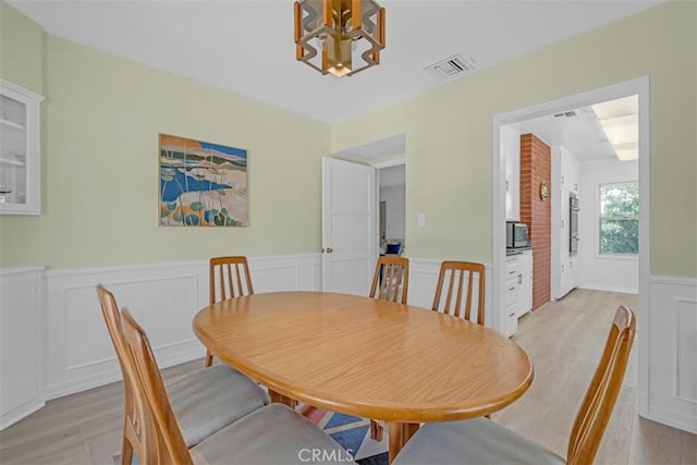 1011 Portola Dr, Arcadia, CA 91007 - dining space featuring a chandelier, a wainscoted wall, light wood-type flooring, and a decorative wall