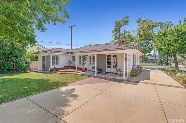 1011 Portola Dr, Arcadia, CA 91007 - rear view of house featuring french doors, a lawn, a chimney, and stucco siding