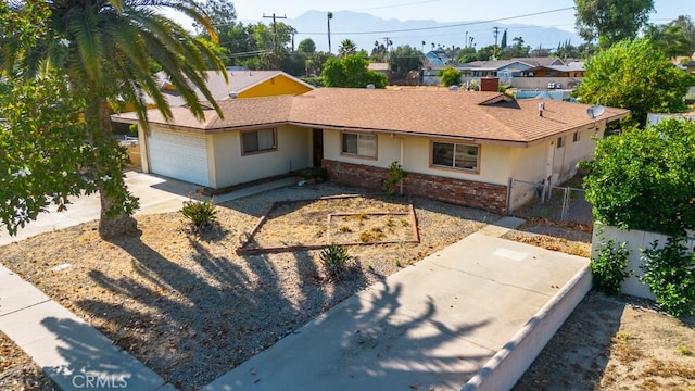 17480 Fontlee Ln, Fontana, CA 92335 - ranch-style house featuring an attached garage, brick siding, stucco siding, and driveway