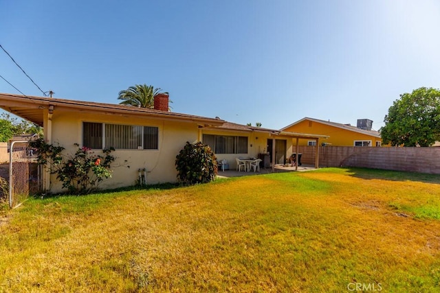 17480 Fontlee Ln, Fontana, CA 92335 - back of property featuring a patio area, stucco siding, and a chimney