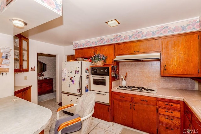 17480 Fontlee Ln, Fontana, CA 92335 - kitchen featuring white appliances, light countertops, tasteful backsplash, light tile patterned floors, and a warming drawer