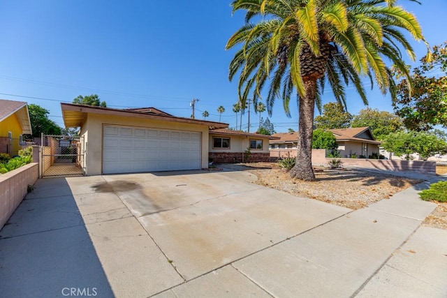 17480 Fontlee Ln, Fontana, CA 92335 - single story home featuring stucco siding, a gate, concrete driveway, and a garage