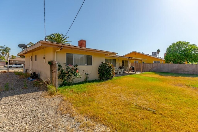 17480 Fontlee Ln, Fontana, CA 92335 - rear view of house with a chimney, stucco siding, and a patio area