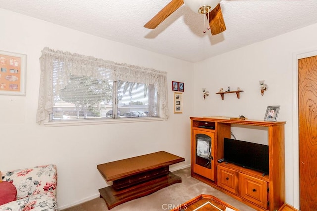17480 Fontlee Ln, Fontana, CA 92335 - living area featuring ceiling fan, carpet, and a textured ceiling
