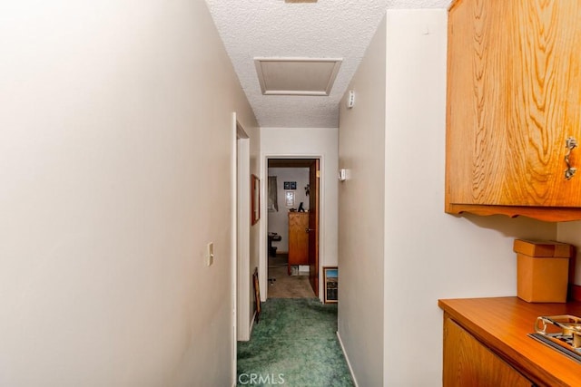 17480 Fontlee Ln, Fontana, CA 92335 - hallway with a textured ceiling, dark carpet, and attic access