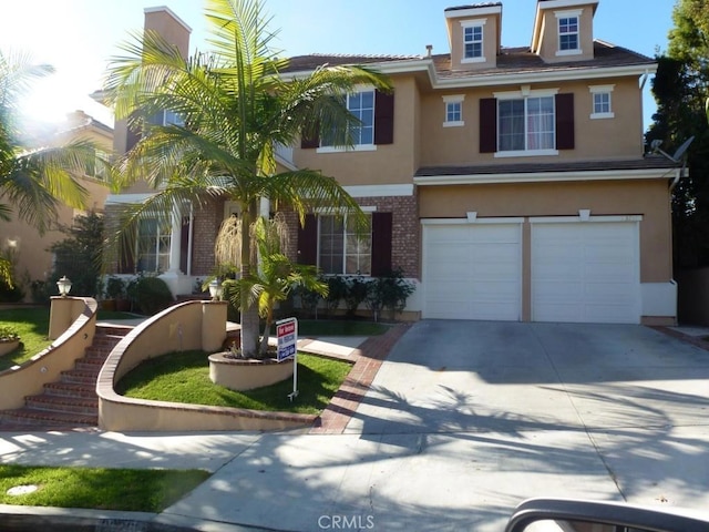 23261 Castle Rock, Mission Viejo, CA 92692 - view of front of home with stucco siding, concrete driveway, a garage, and brick siding