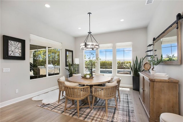 2526 N La Colina Ct, Orange, CA 92867 - dining space with light wood-style flooring, healthy amount of natural light, a barn door, recessed lighting, and a chandelier