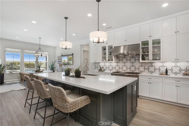 2526 N La Colina Ct, Orange, CA 92867 - kitchen with exhaust hood, decorative backsplash, white cabinetry, light countertops, and recessed lighting