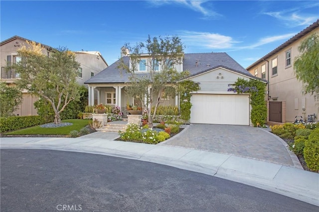 2526 N La Colina Ct, Orange, CA 92867 - view of front facade with an attached garage, driveway, covered porch, a chimney, and stucco siding