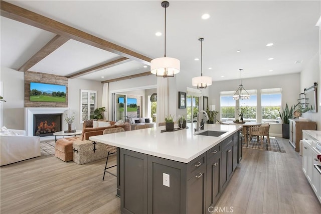 2526 N La Colina Ct, Orange, CA 92867 - kitchen featuring light countertops, light wood-style flooring, open floor plan, recessed lighting, and beam ceiling