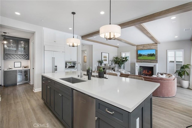 2526 N La Colina Ct, Orange, CA 92867 - kitchen with beverage cooler, stainless steel dishwasher, paneled fridge, light wood-style flooring, and beam ceiling