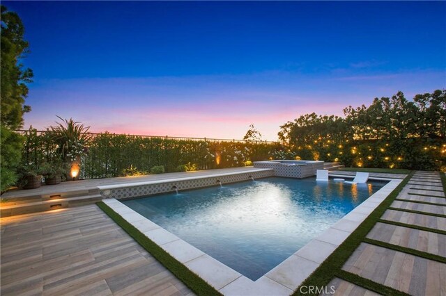 2526 N La Colina Ct, Orange, CA 92867 - pool at dusk featuring a fenced backyard and a pool with connected hot tub