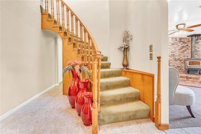 929 9th St, Williams, CA 95987 - stairs featuring a wood stove, tile patterned floors, and a ceiling fan