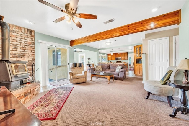 929 9th St, Williams, CA 95987 - living area with ceiling fan, light colored carpet, beam ceiling, a wood stove, and recessed lighting