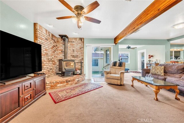 929 9th St, Williams, CA 95987 - living area featuring carpet flooring, ceiling fan, a wood stove, and beamed ceiling