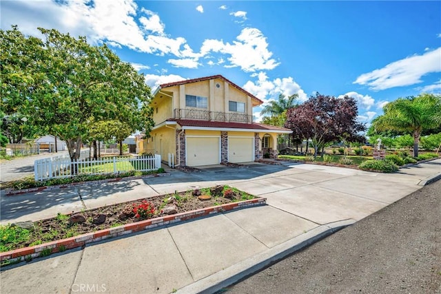 929 9th St, Williams, CA 95987 - view of front of home featuring an attached garage, concrete driveway, stucco siding, and stone siding