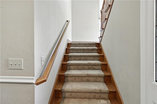 524 St Kevin Ct, Merced, CA 95348 - staircase with wood finished floors and a textured wall