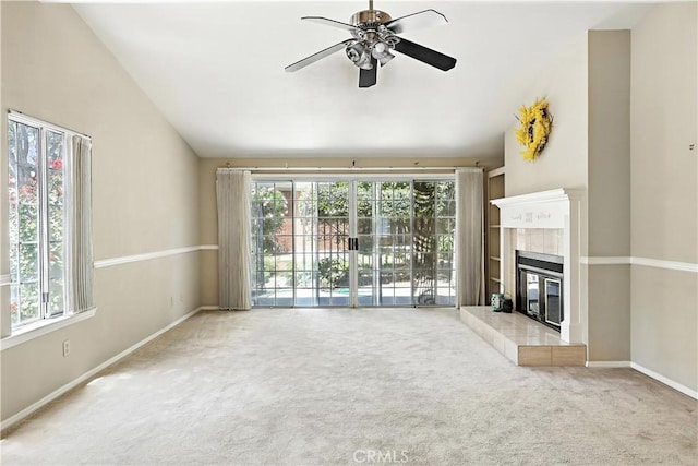 524 St Kevin Ct, Merced, CA 95348 - unfurnished living room with a ceiling fan, carpet, a tile fireplace, and vaulted ceiling