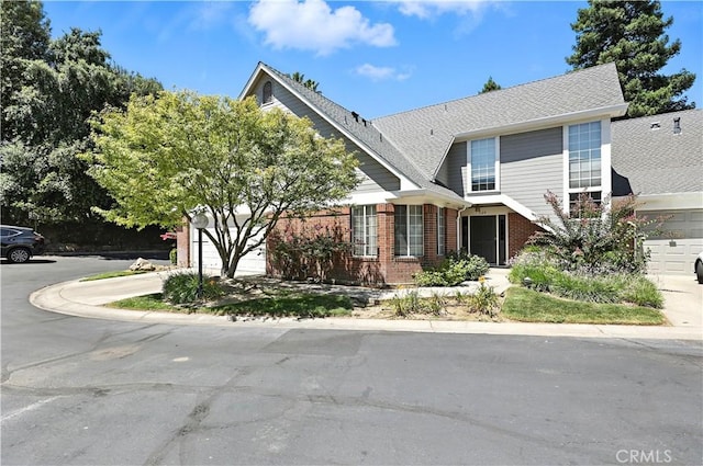 524 St Kevin Ct, Merced, CA 95348 - view of front of property with concrete driveway, brick siding, and a garage