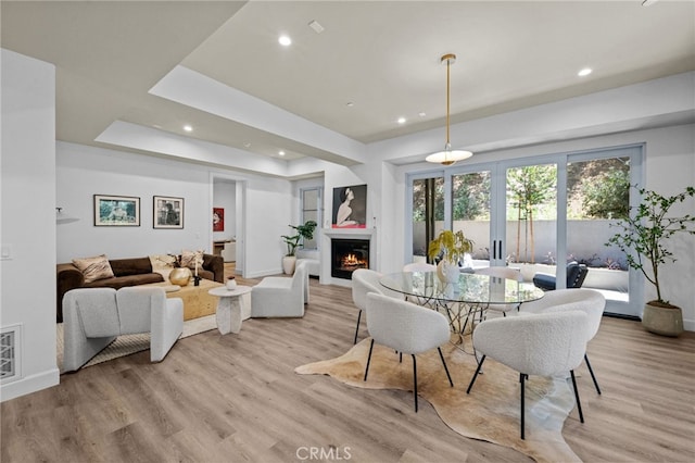 620 Baldwin Ct, Sierra Madre, CA 91024 - dining area with light wood-style floors, a lit fireplace, recessed lighting, and a raised ceiling