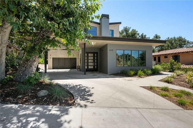 620 Baldwin Ct, Sierra Madre, CA 91024 - view of front of home featuring concrete driveway, an attached garage, and a chimney