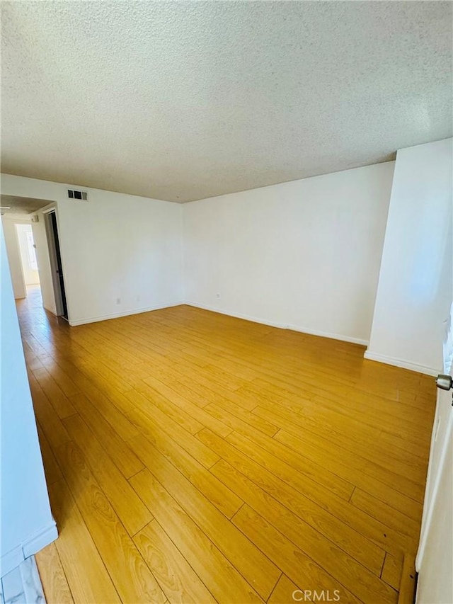 5484 Dobbs St Unit 132, Los Angeles, CA 90032 - spare room with a textured ceiling and light wood finished floors