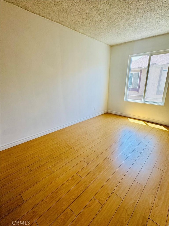 5484 Dobbs St Unit 132, Los Angeles, CA 90032 - unfurnished room with light wood-style flooring and a textured ceiling